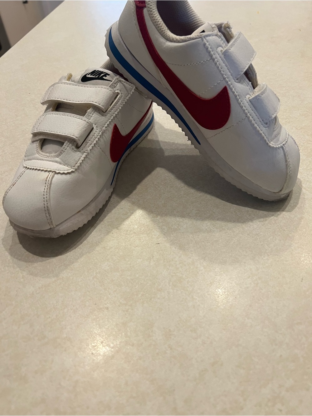 Nike Kids White Sneakers with Red Swoosh and Blue Stripe
